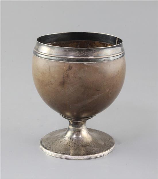 A George III silver mounted pedestal coconut cup, by Phipps & Robinson, height 13.4cm.